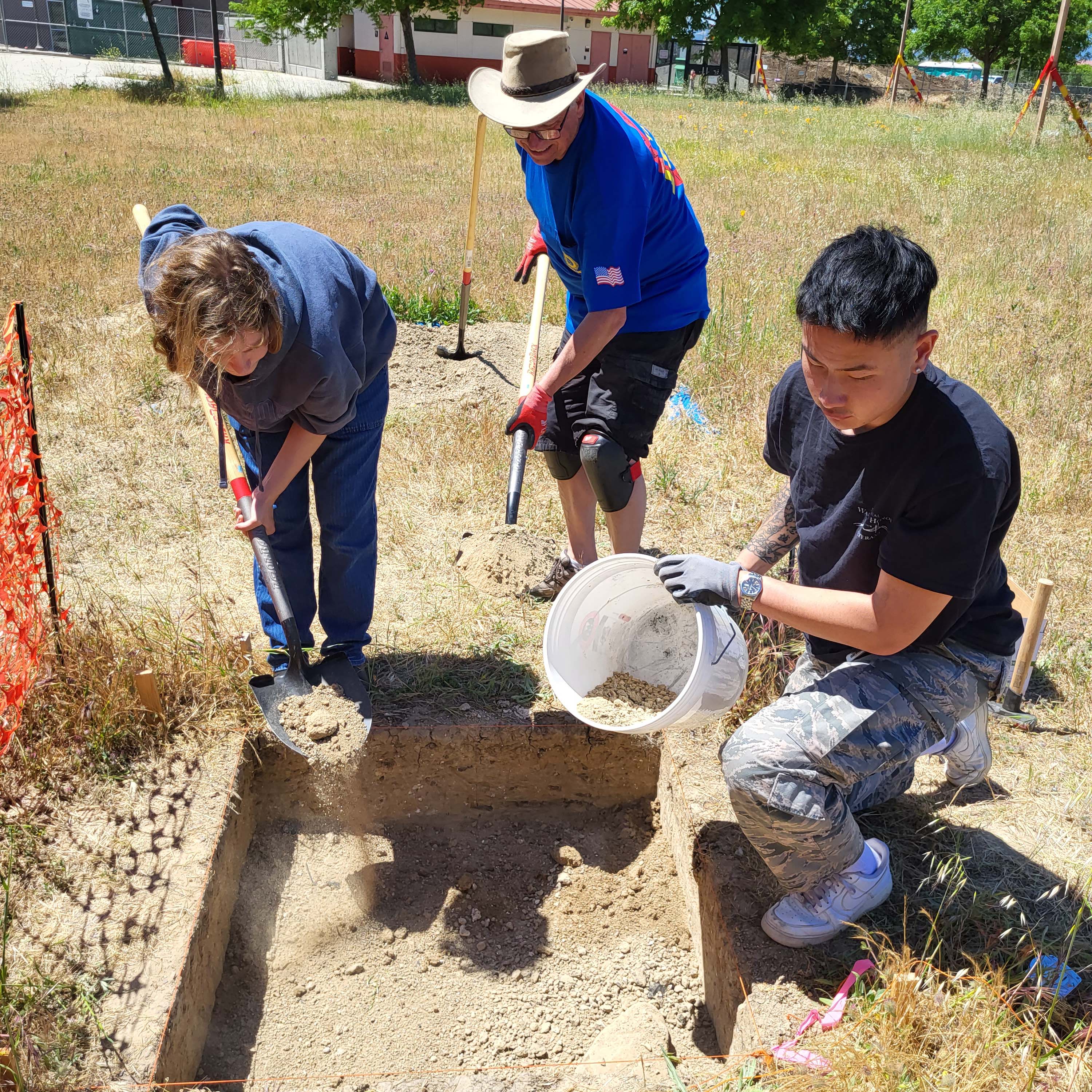Students excavting a 1 by 1 meter test pit