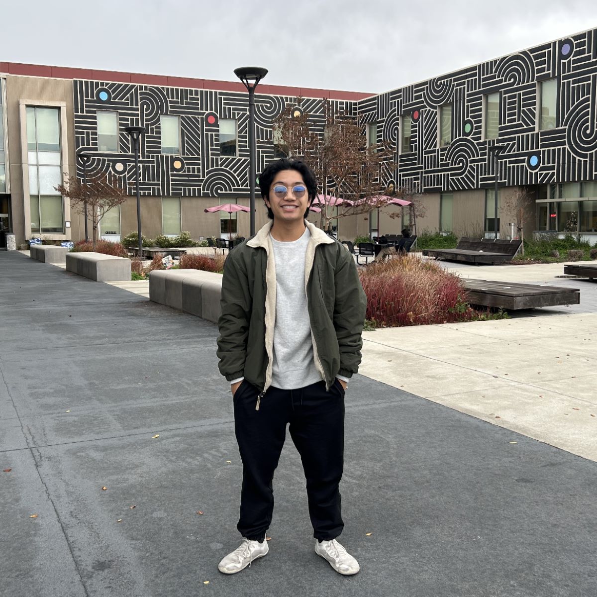 student in front of buidling student in front of building