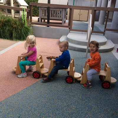 Children playing on scooters.