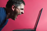 man yelling at laptop