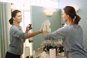 woman cleaning mirror