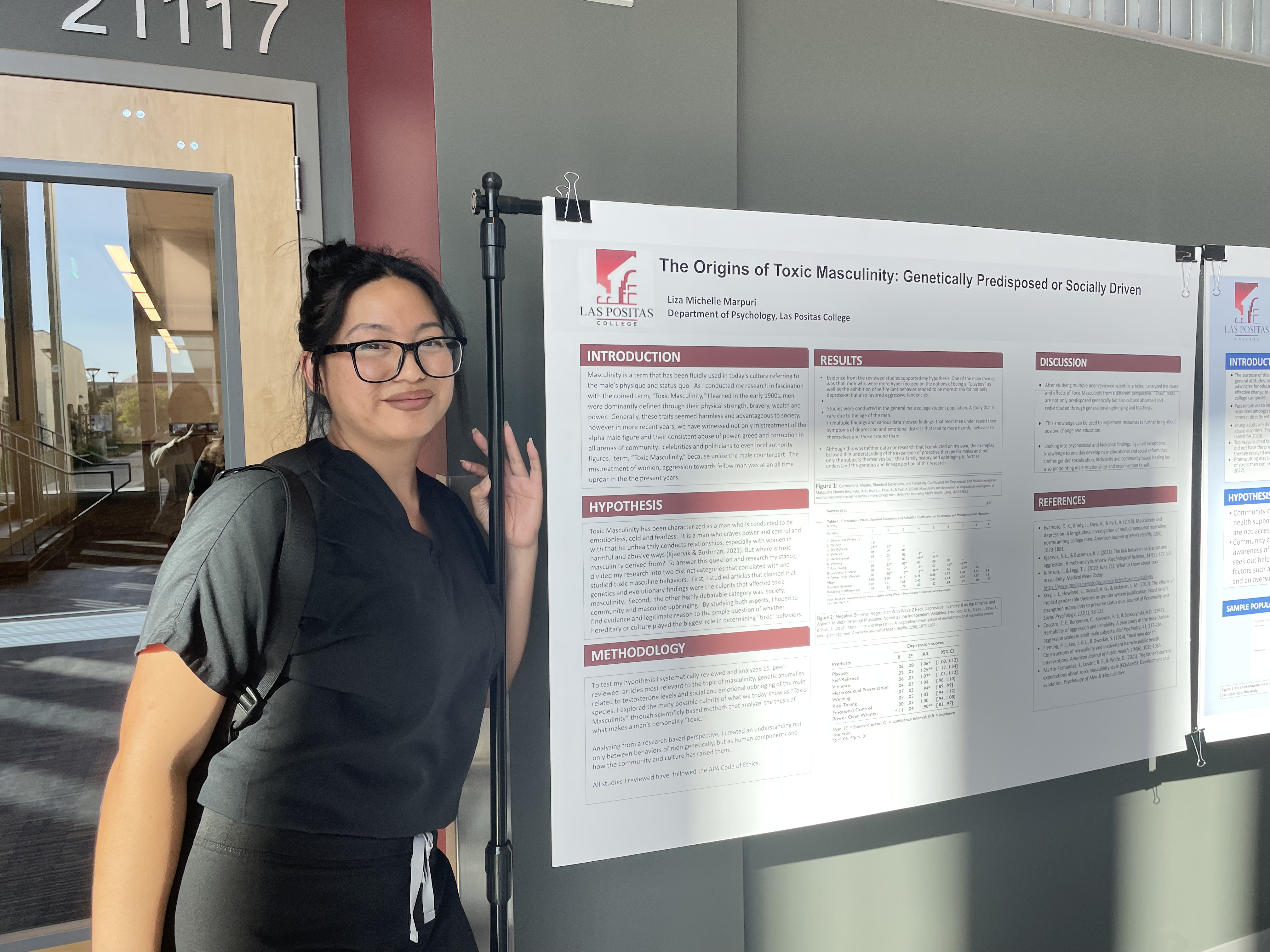 Liza stands next to her poster